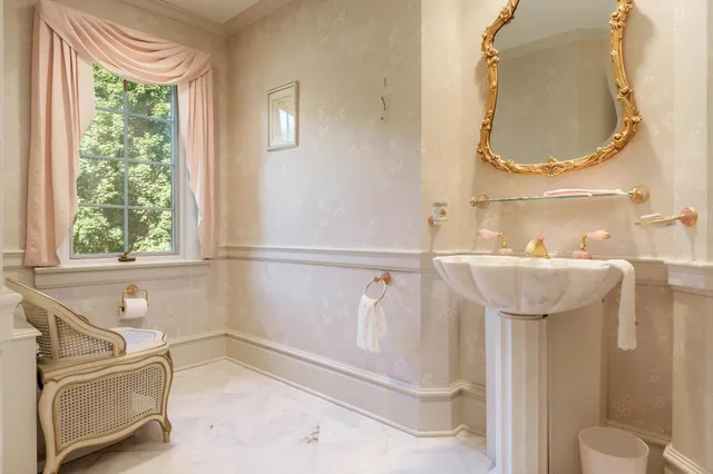 a view of a livingroom with furniture and floor to ceiling window