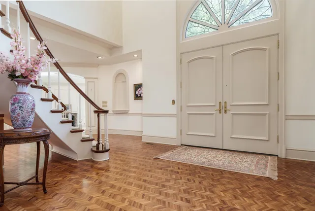 a view of entryway and hall with wooden floor