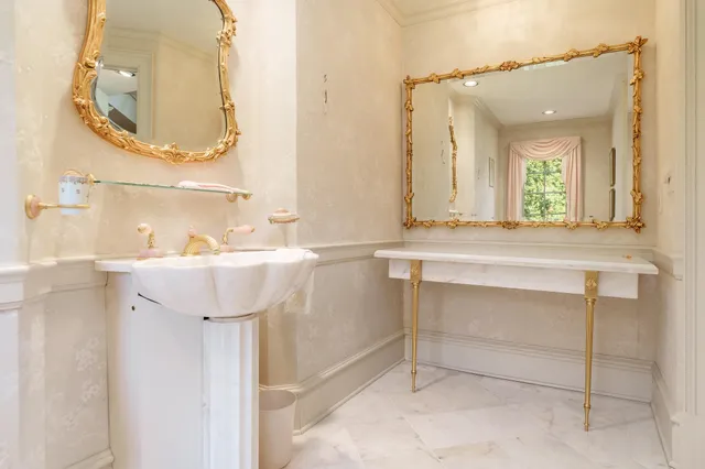 a bathroom with a sink toilet a mirror and window