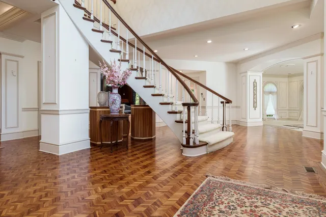 a view of a hallway view with wooden floor and staircase