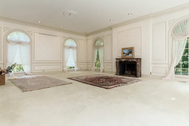 a view of a hallway with wooden floor and a floor to ceiling window