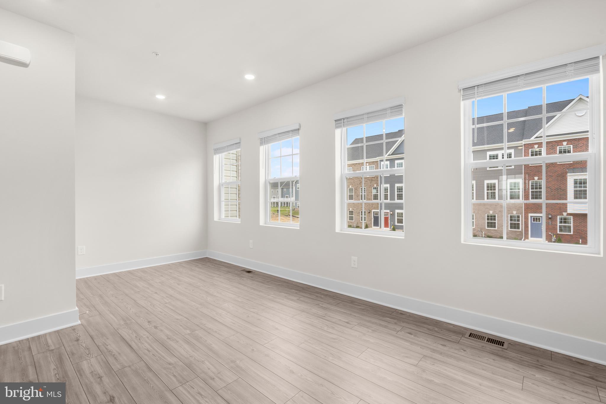 1826 Parham Way Windsor Mill, MD 21244 - Photo 14 of 37 a view of an empty room with a window and wooden floor