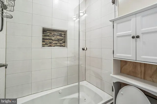 a bathroom with a shower and toilet