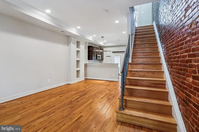 a view of entryway and hall with wooden floor