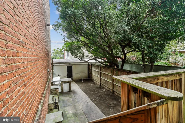 a view of house with backyard and sitting area