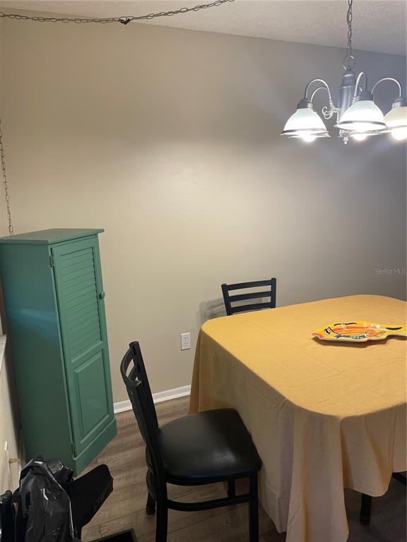 14531 Walsingham Road, Unit 203 Largo, FL 33774 - Photo 4 of 24 a dining room with a table and chairs