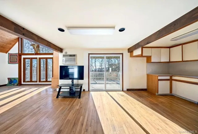 a spacious bedroom with a bed and large windows