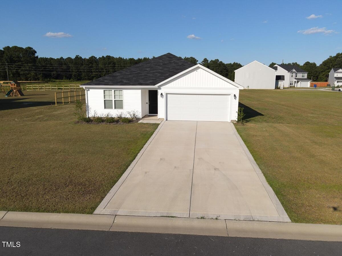 a view of front door and small yard