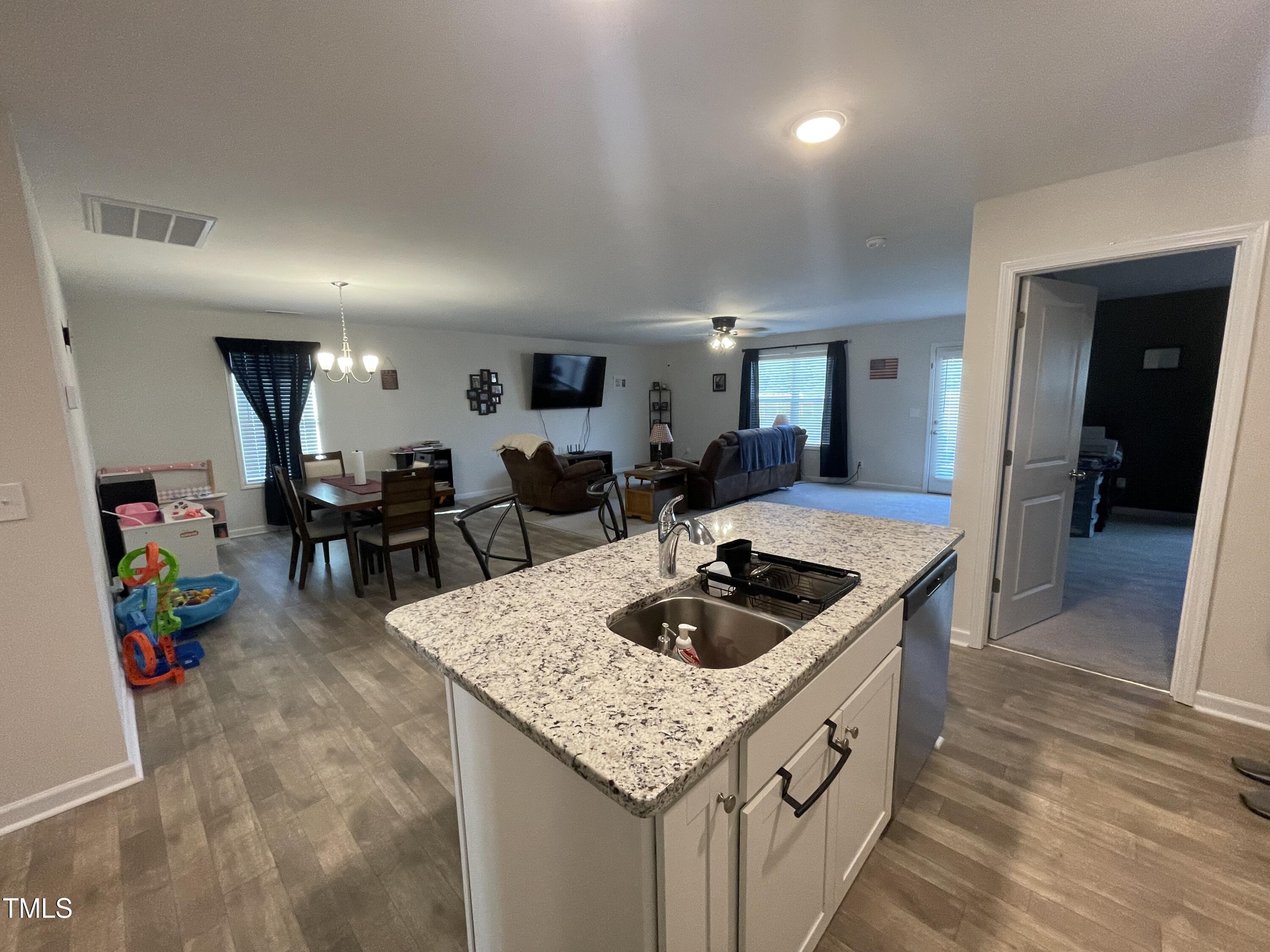 195 Presley Street Raeford, NC 28376 - Photo 11 of 37 a kitchen with a sink a counter and cabinets