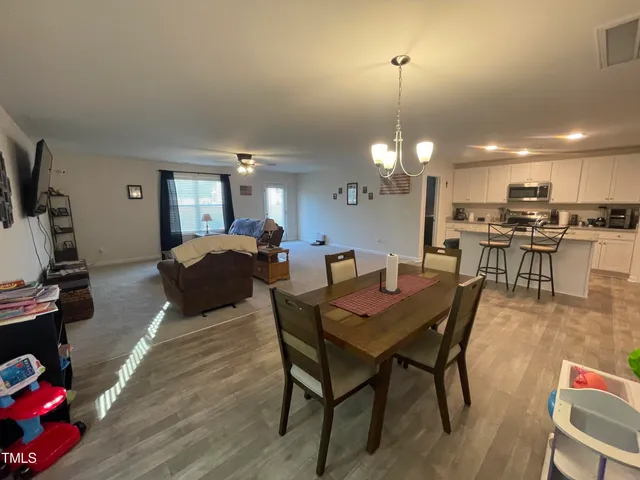 a spacious bedroom with a bed and a chandelier