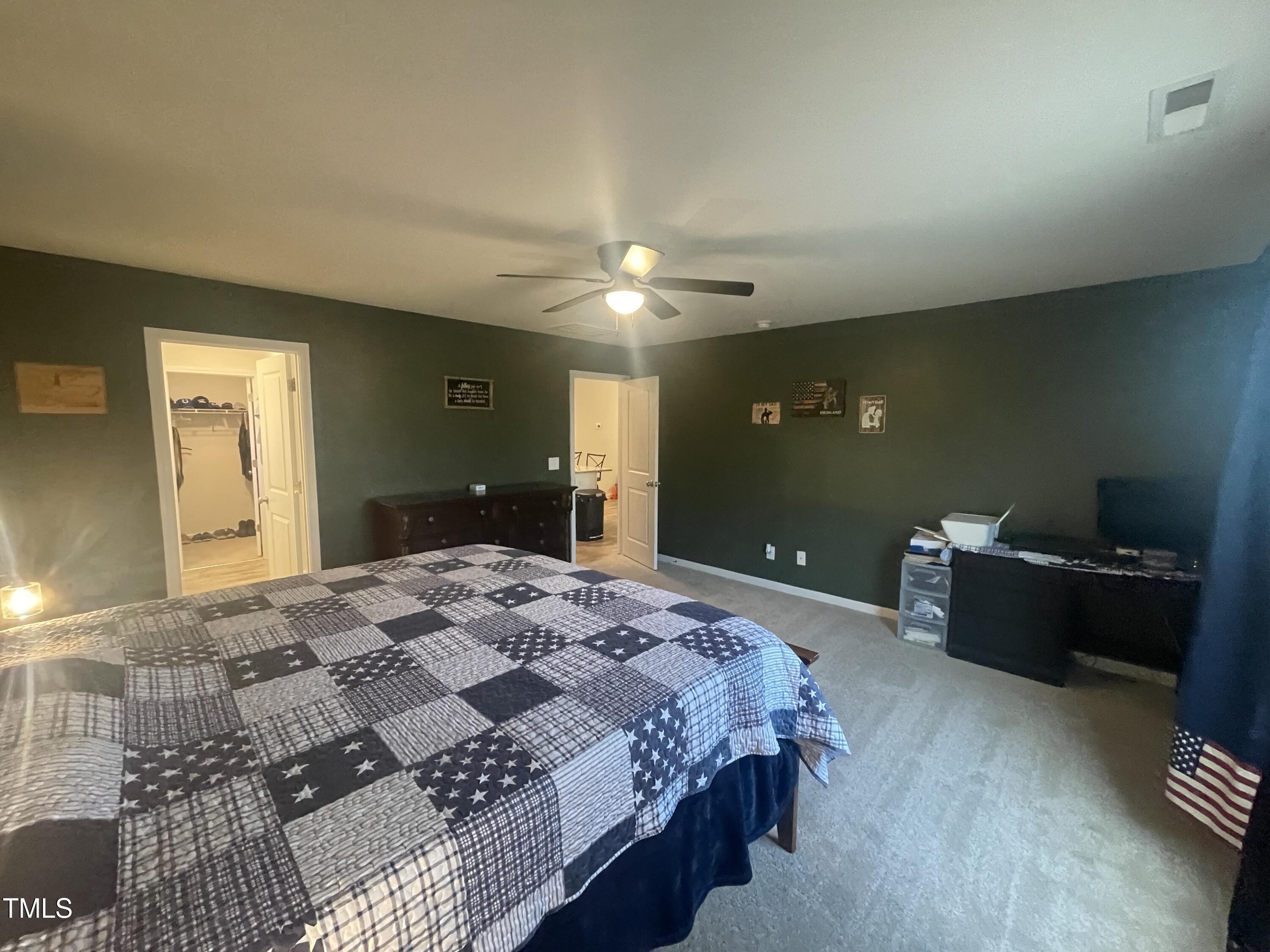 195 Presley Street Raeford, NC 28376 - Photo 20 of 37 a bedroom with a bed and a chandelier