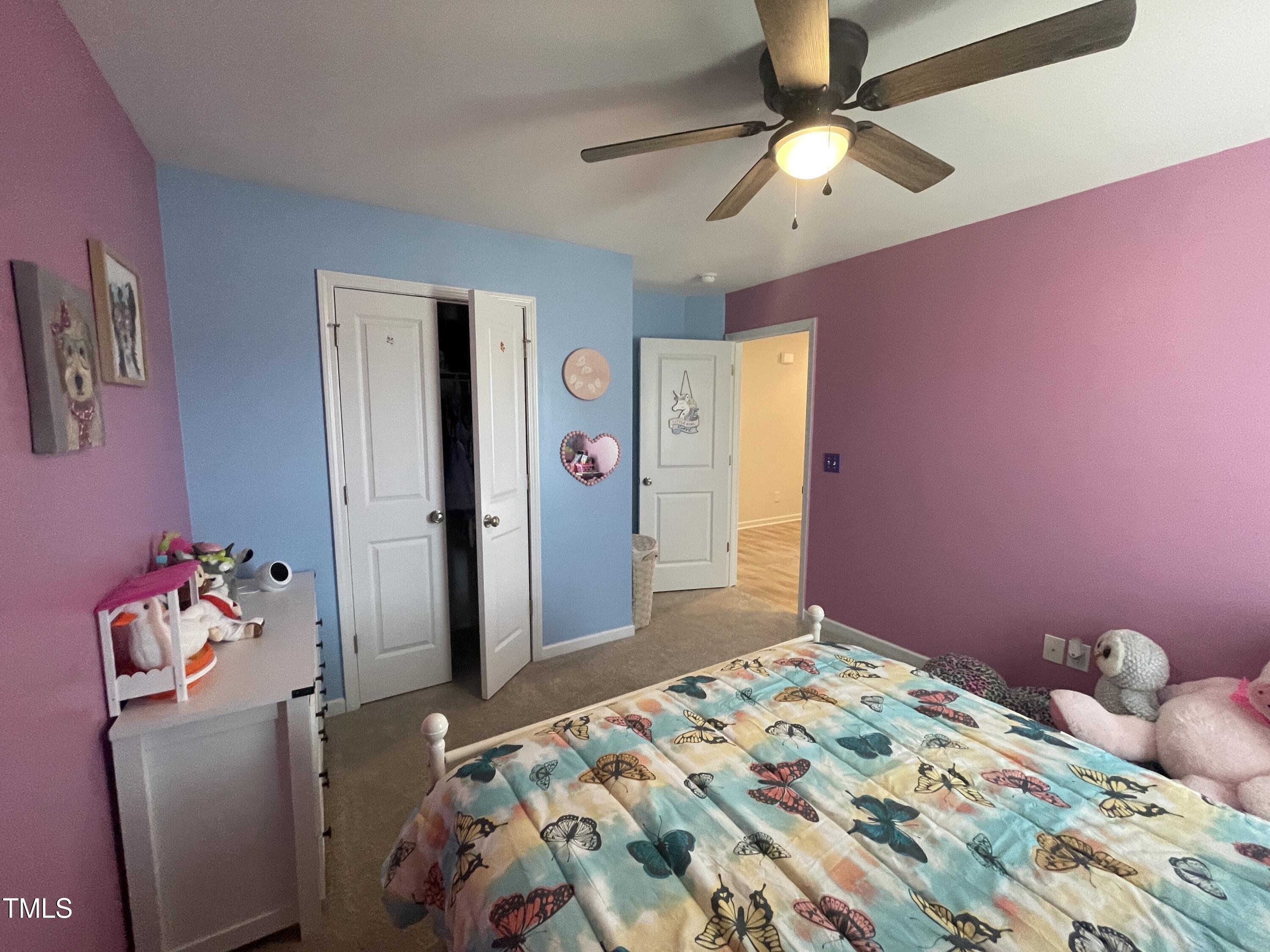 195 Presley Street Raeford, NC 28376 - Photo 28 of 37 a bedroom with a bed and a chandelier