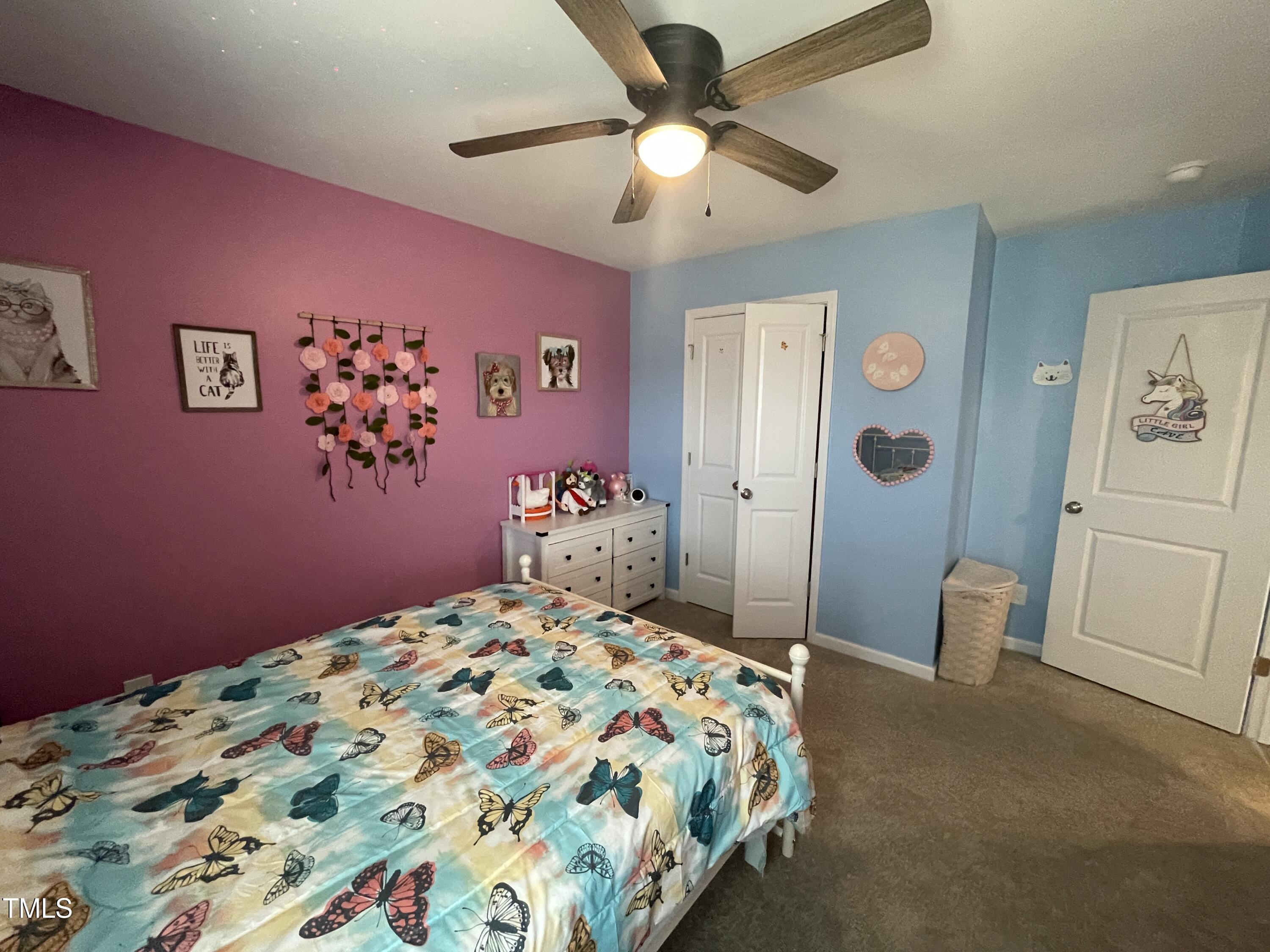 195 Presley Street Raeford, NC 28376 - Photo 29 of 37 a bedroom with a bed and a chandelier