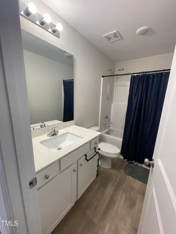 a bedroom with a bed dresser and a window