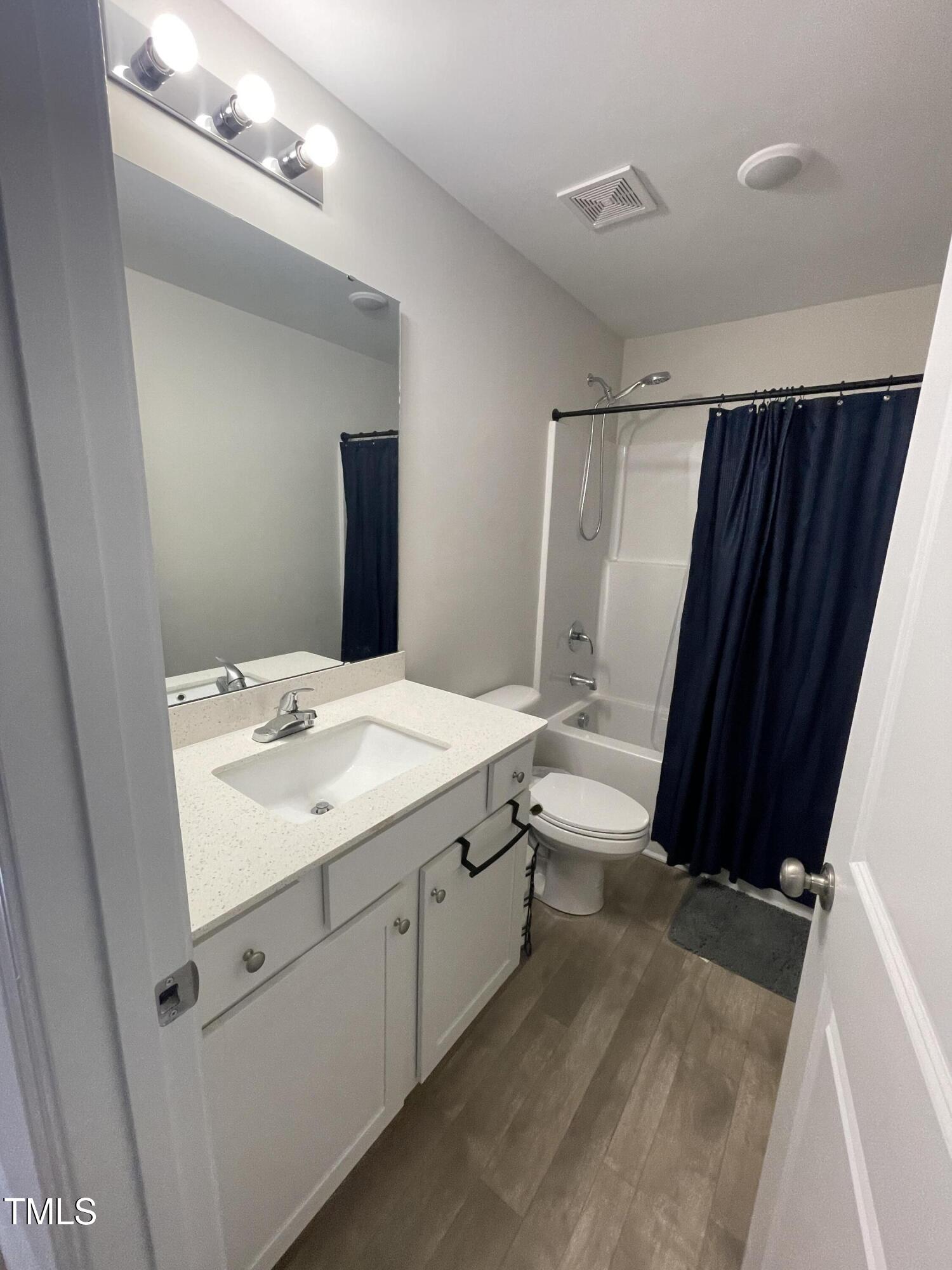 195 Presley Street Raeford, NC 28376 - Photo 30 of 37 a bathroom with a sink a toilet a mirror and shower