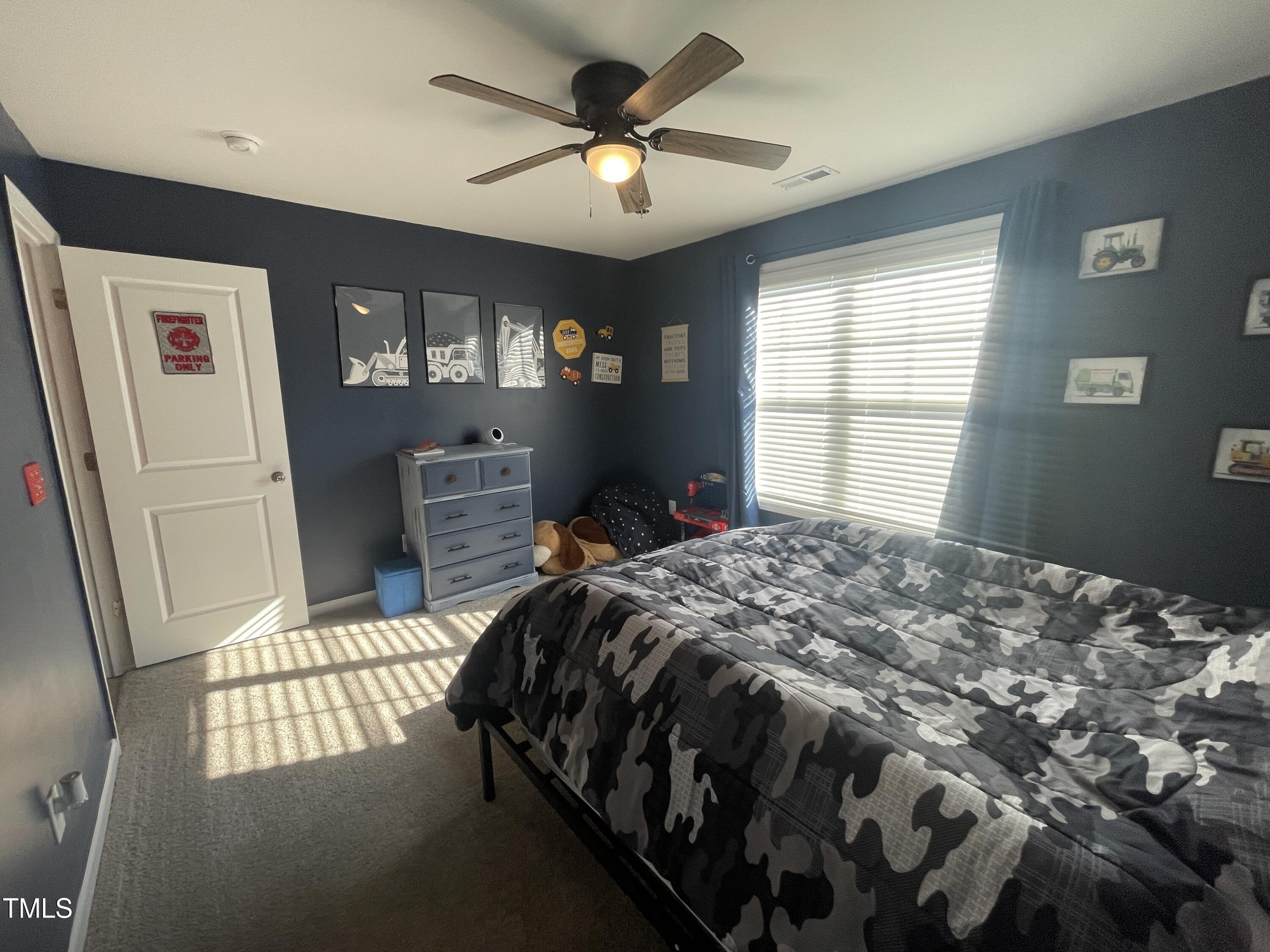 195 Presley Street Raeford, NC 28376 - Photo 32 of 37 a bedroom with a bed dresser and a window