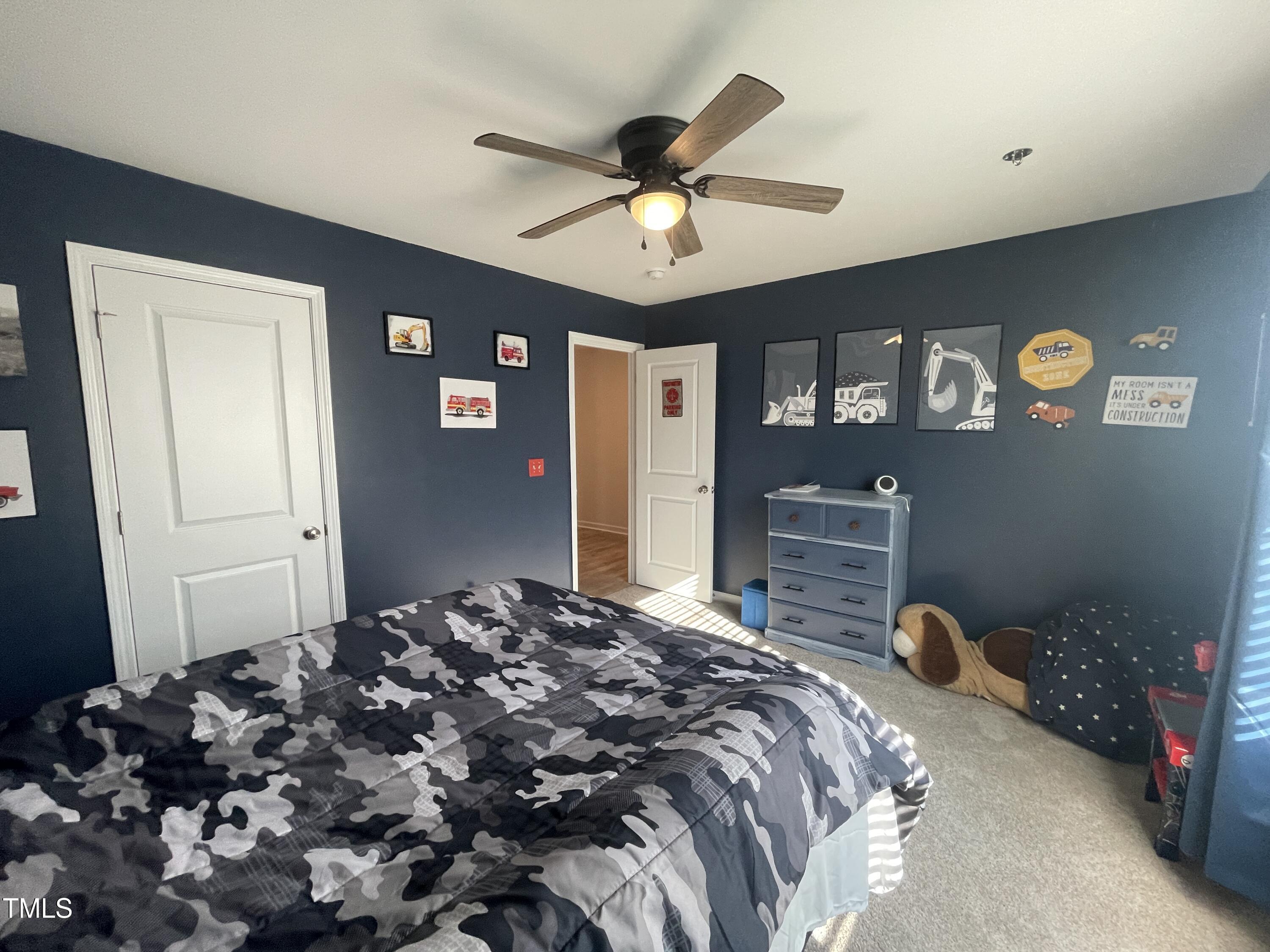 195 Presley Street Raeford, NC 28376 - Photo 33 of 37 a bedroom with a bed and a chandelier