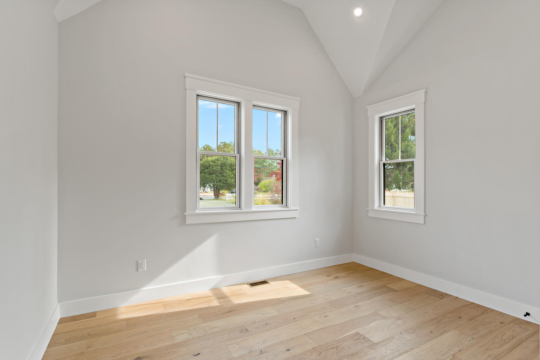 99 Orchard Road Mashpee, MA 02649 - Photo 28 of 49 an empty room with wooden floor and windows