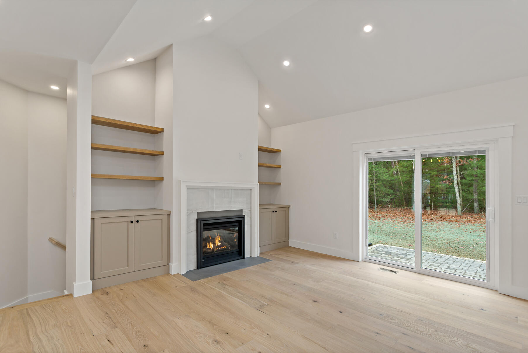 99 Orchard Road Mashpee, MA 02649 - Photo 31 of 49 a view of an empty room with a fireplace and a window