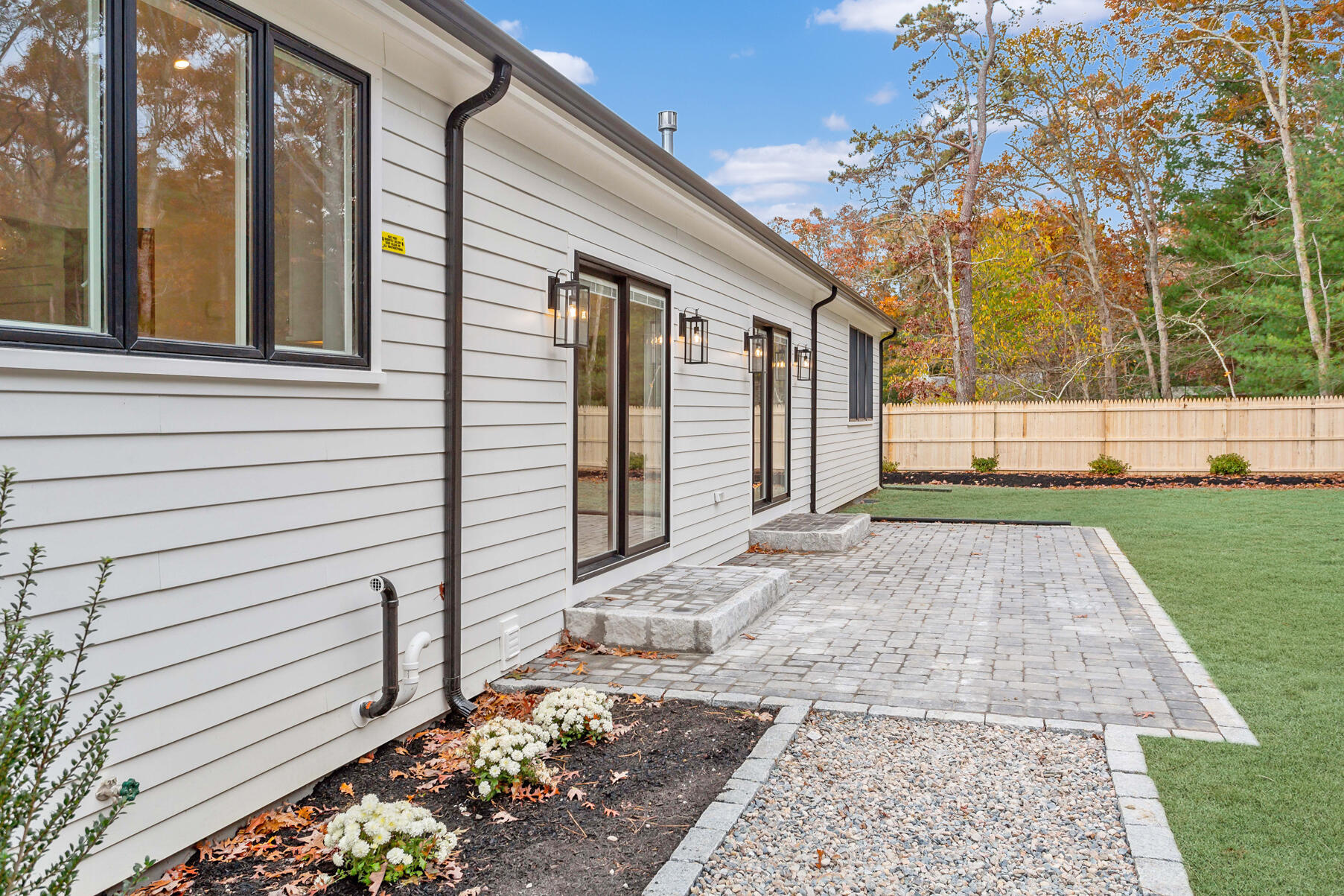 99 Orchard Road Mashpee, MA 02649 - Photo 35 of 49 a view of a white house with a yard
