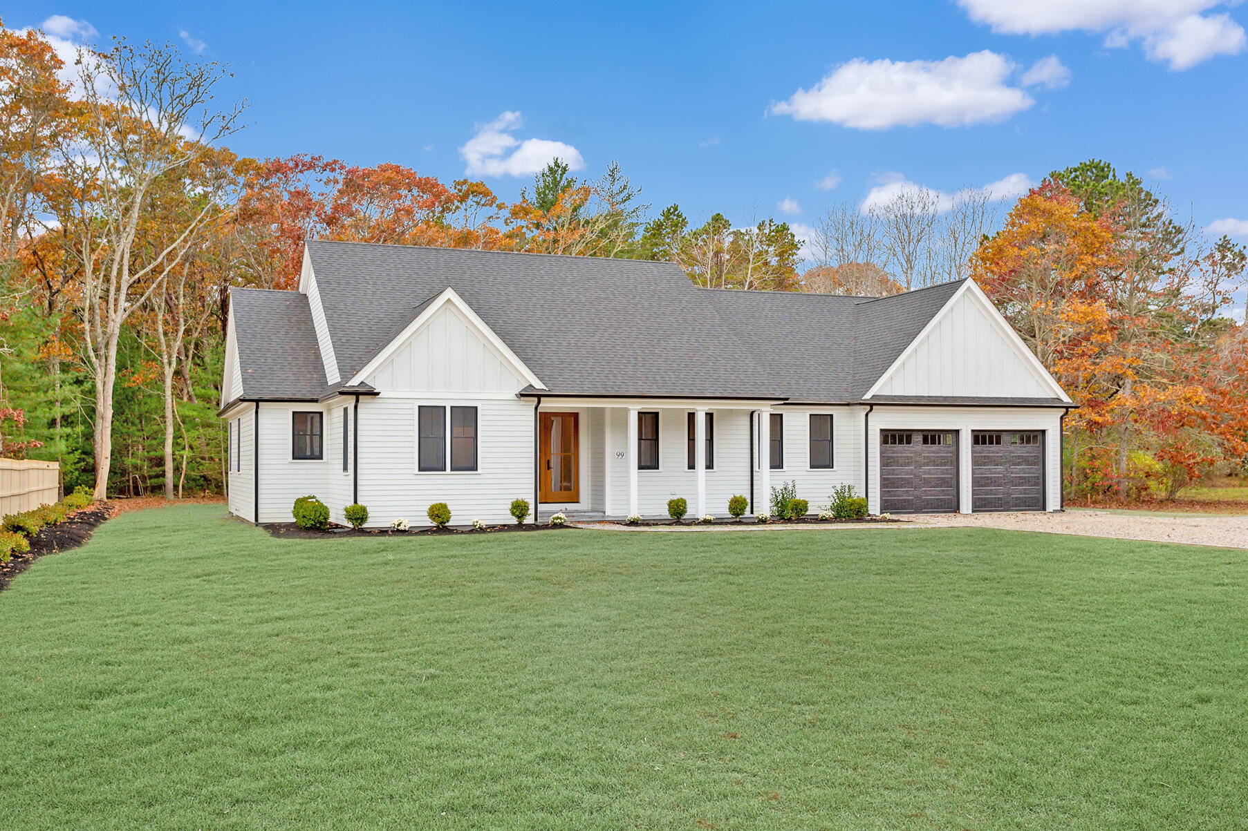 99 Orchard Road Mashpee, MA 02649 - Photo 4 of 49 a view of a house with a big yard and large trees