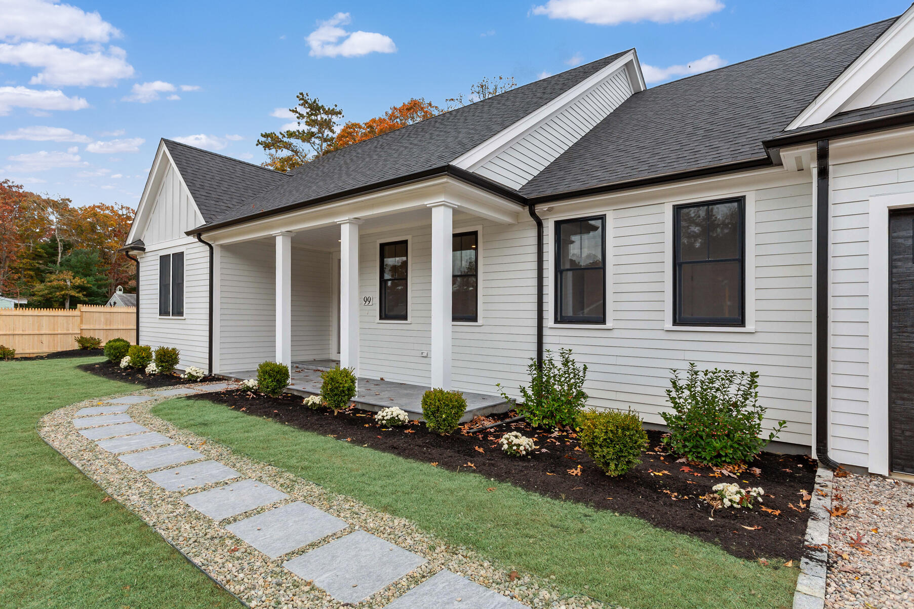 99 Orchard Road Mashpee, MA 02649 - Photo 5 of 49 a front view of a house with a garden