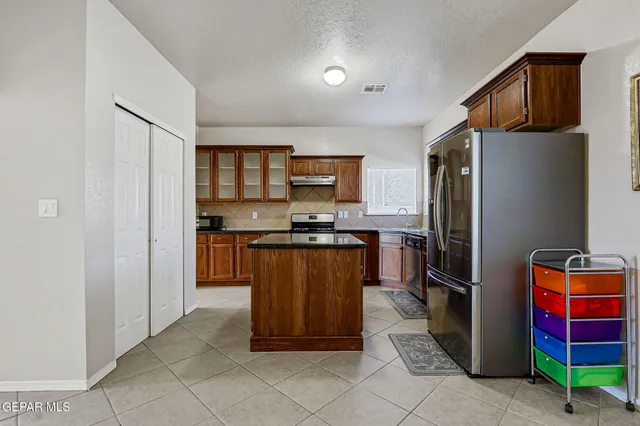 a living room with furniture and kitchen view