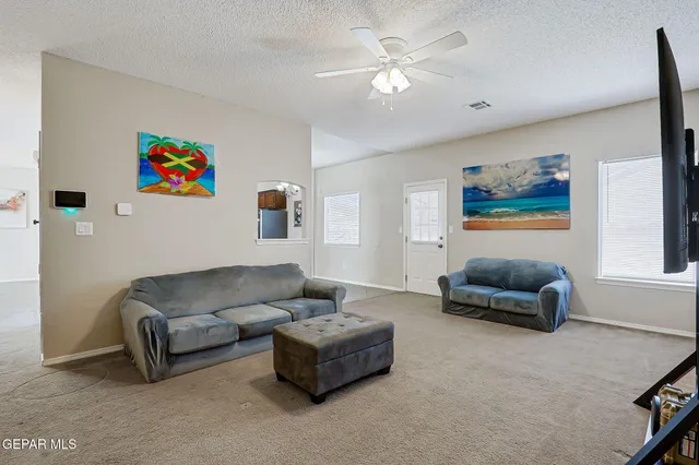 a view of a livingroom with furniture and chandelier