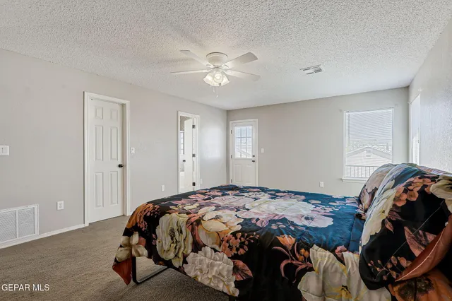 a bathroom with a sink a large mirror and a light fixture