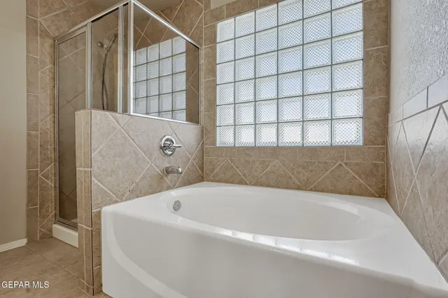 an empty room with a ceiling fan and window