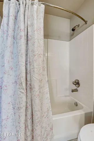 an aerial view of a city with lots of residential buildings and mountain view in back