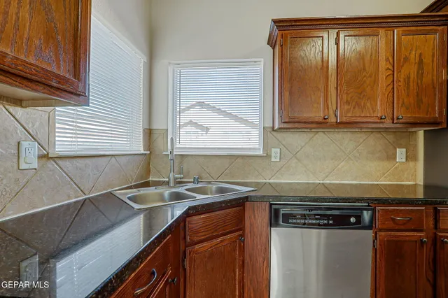 a kitchen with a sink and cabinets