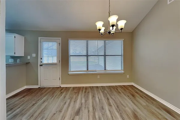 a view of wooden floor and chandelier in a room