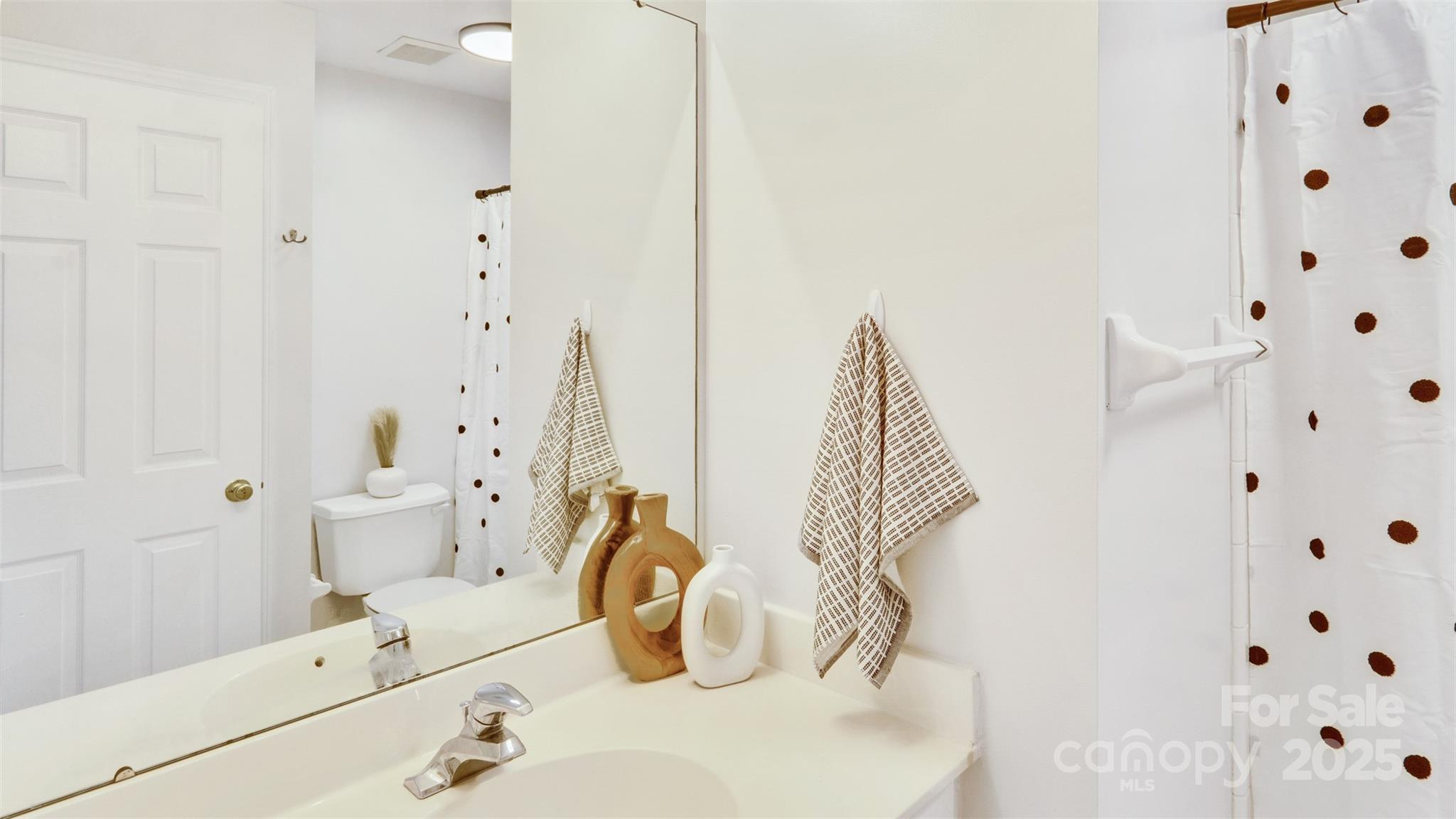 3309 Stettler View Road Charlotte, NC 28210 - Photo 22 of 29 a bathroom with a sink and mirror with toilet