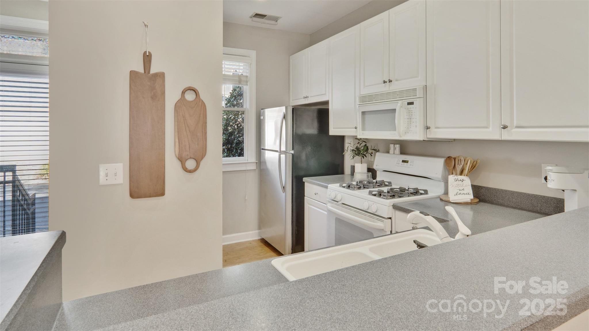 3309 Stettler View Road Charlotte, NC 28210 - Photo 3 of 29 a kitchen with stainless steel appliances granite countertop a refrigerator a stove and a sink