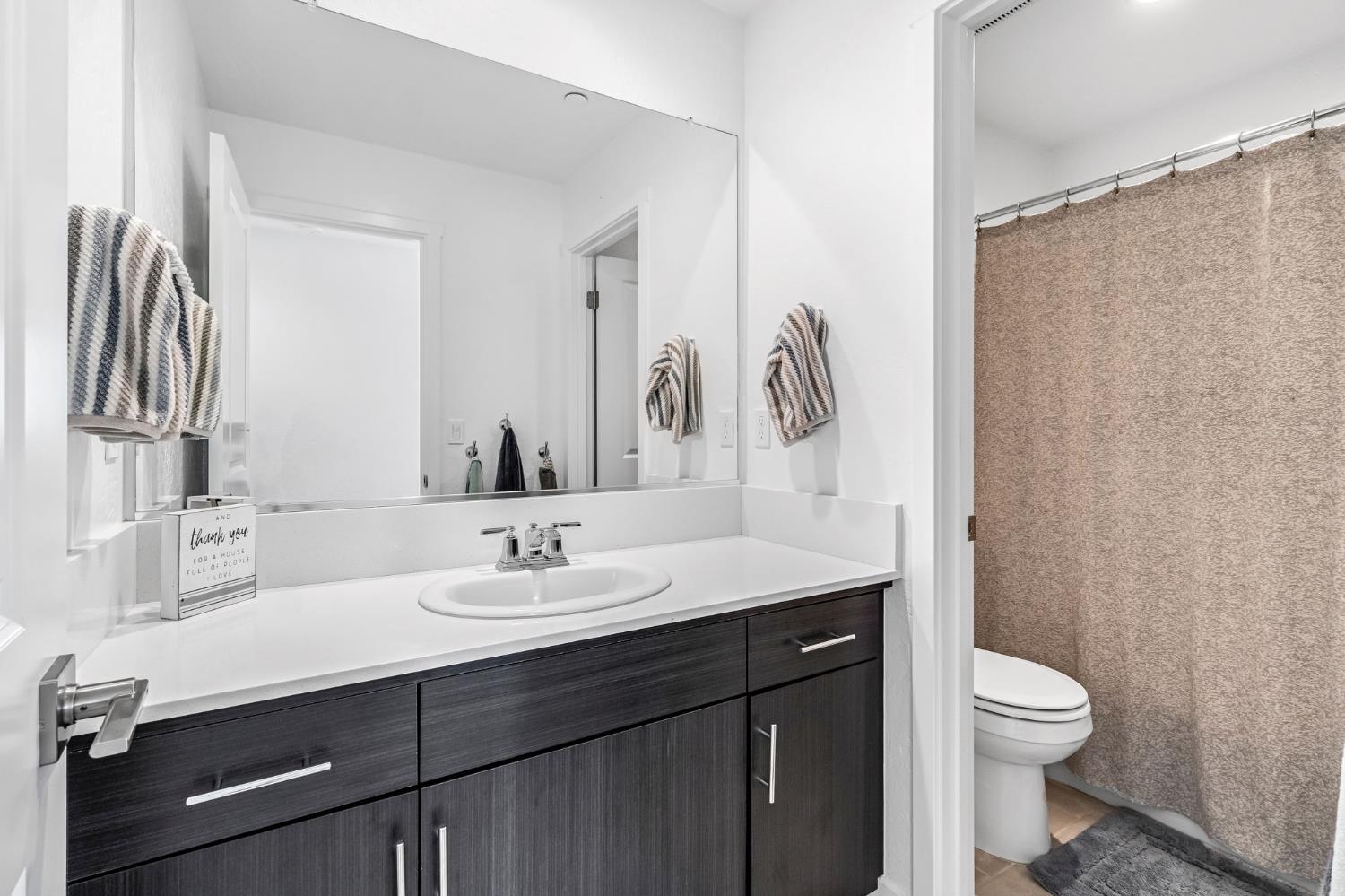 367 Talus Way South Madera, CA 93636 - Photo 24 of 40 a bathroom with a granite countertop sink toilet and a mirror