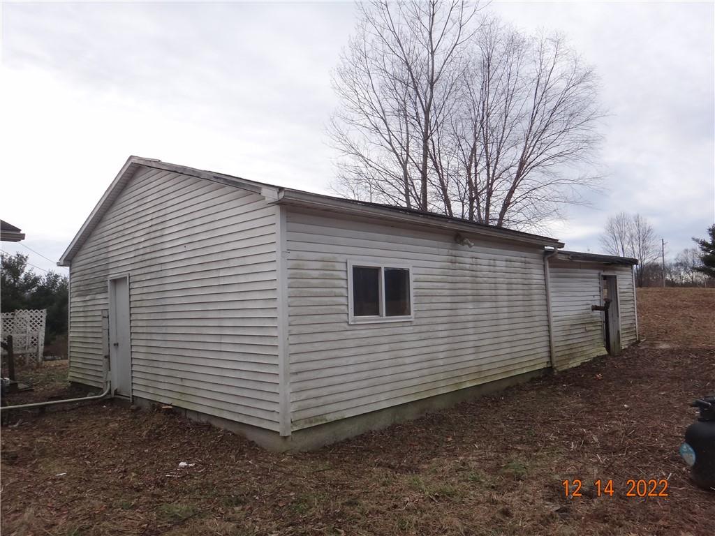 471 Millburn Road Mercer, PA 16137 - Photo 21 of 24 a view of a house with a yard and garage