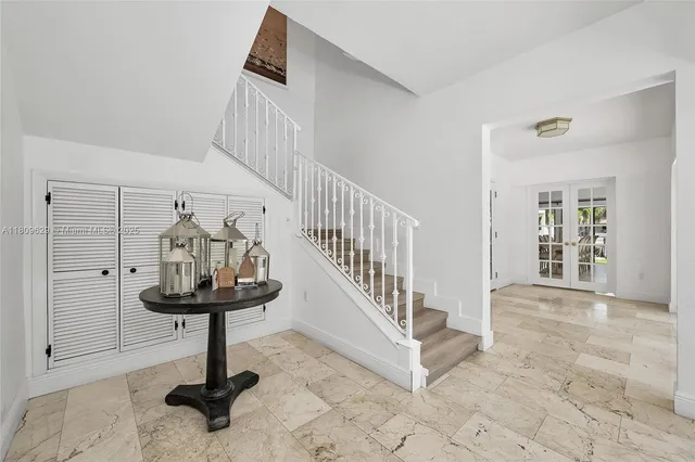 a spacious bedroom with a bed and a large window