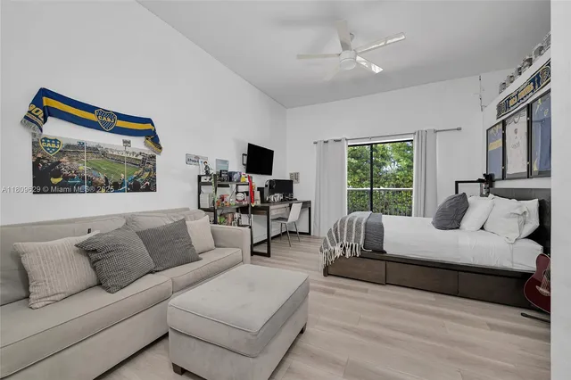 a front view of a building with garden and trees