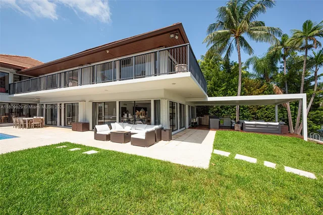a view of a patio with table and chairs potted plants with wooden floor and fence