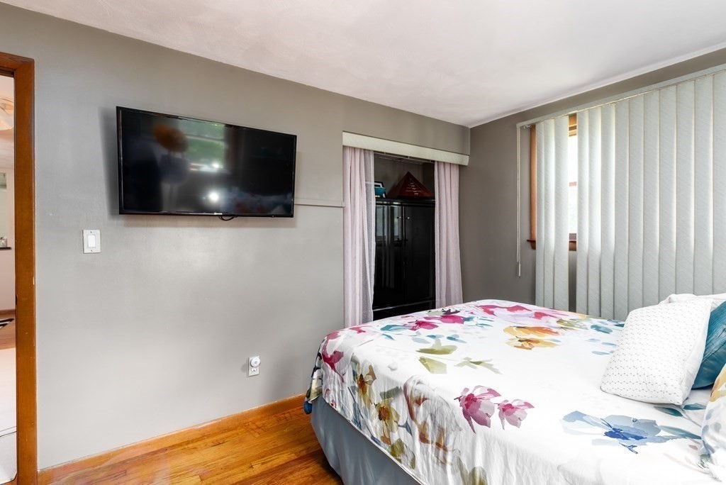 126 Baldwin Road Billerica, MA 01821 - Photo 12 of 30 a bedroom with a bed and a flat screen tv