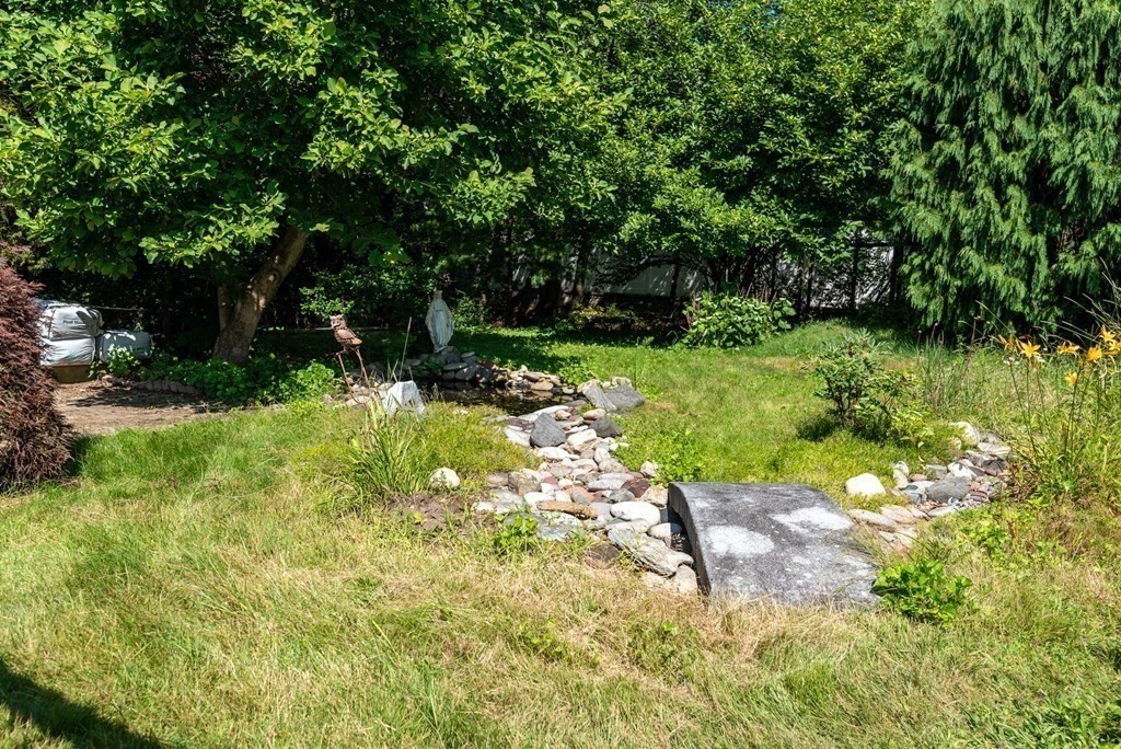 126 Baldwin Road Billerica, MA 01821 - Photo 19 of 30 a backyard of a house with lots of green space