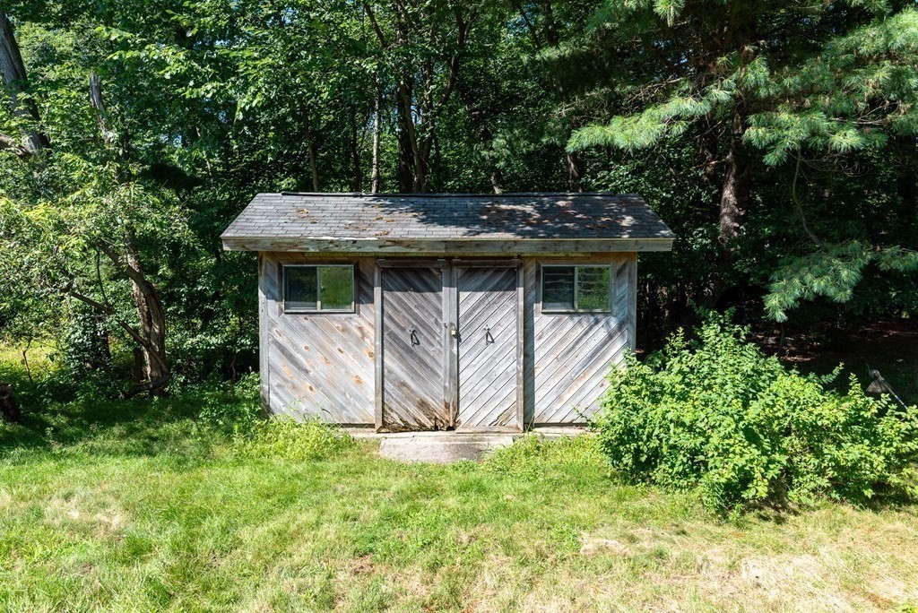 126 Baldwin Road Billerica, MA 01821 - Photo 23 of 30 a view of a backyard with plants and large trees