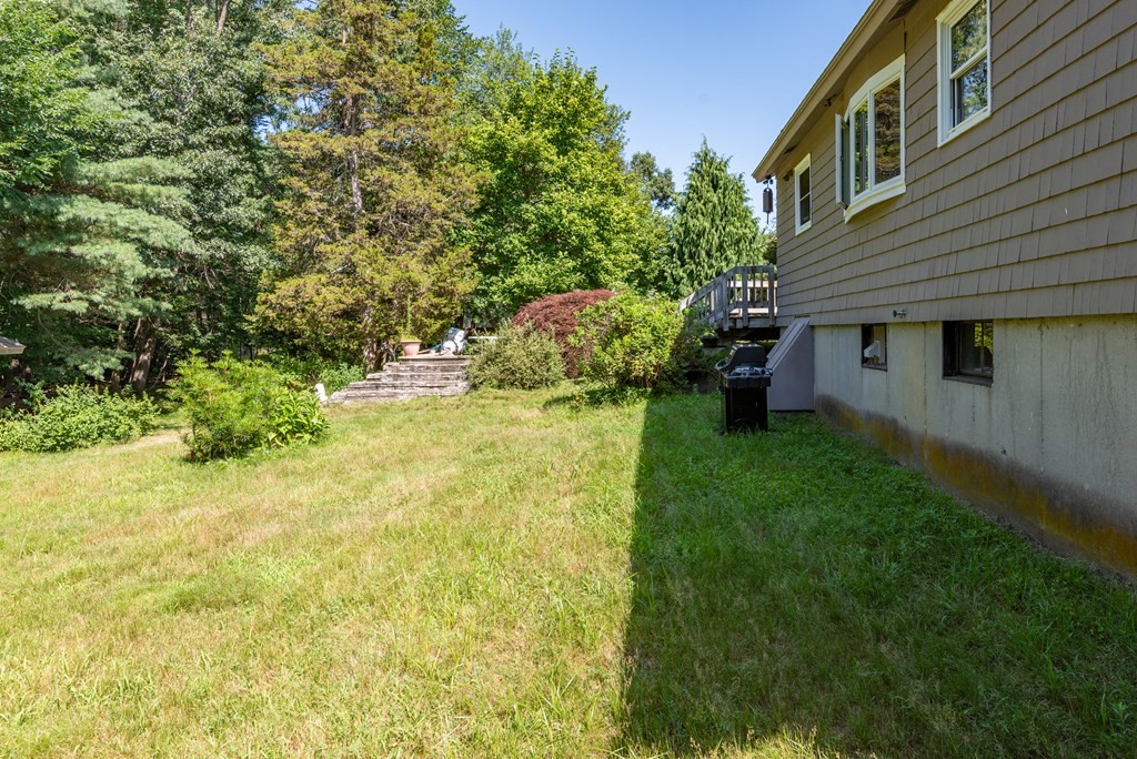 126 Baldwin Road Billerica, MA 01821 - Photo 29 of 30 a backyard of a house with plants and large tree