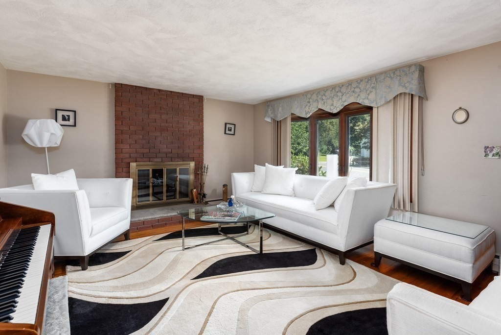 126 Baldwin Road Billerica, MA 01821 - Photo 3 of 30 a living room with furniture and a fireplace