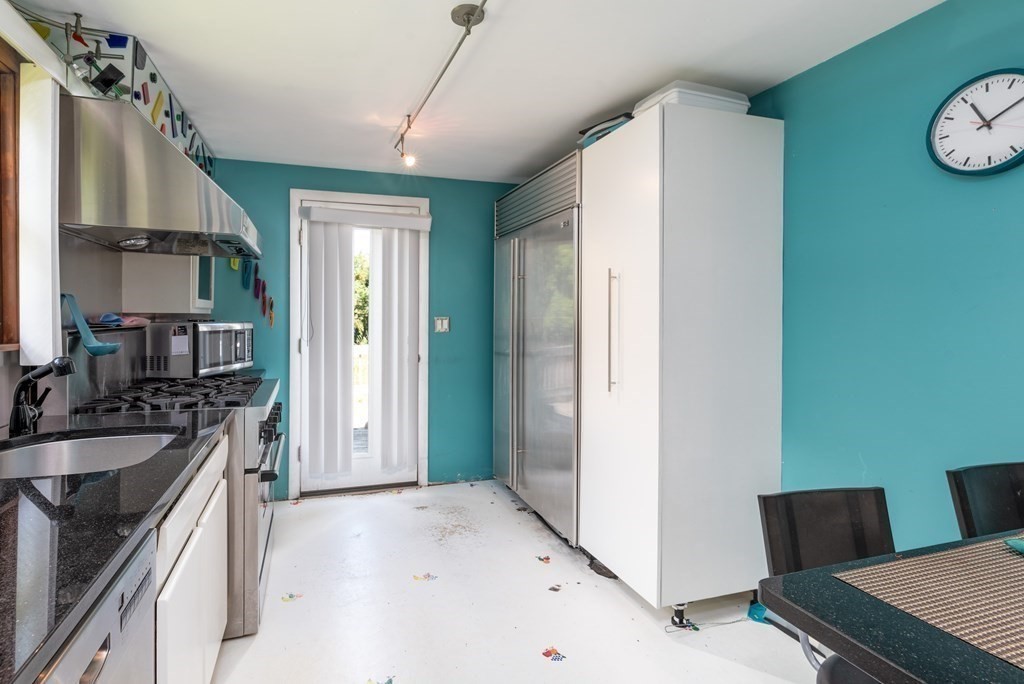 126 Baldwin Road Billerica, MA 01821 - Photo 7 of 30 a kitchen with a sink and a refrigerator