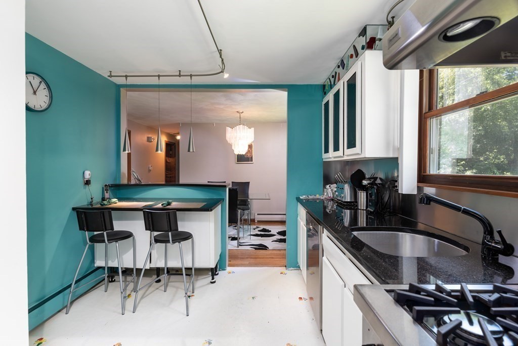 126 Baldwin Road Billerica, MA 01821 - Photo 8 of 30 a kitchen with a sink cabinets and window