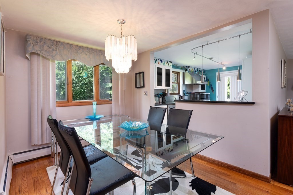 126 Baldwin Road Billerica, MA 01821 - Photo 9 of 30 a dining room with furniture a chandelier and wooden floor