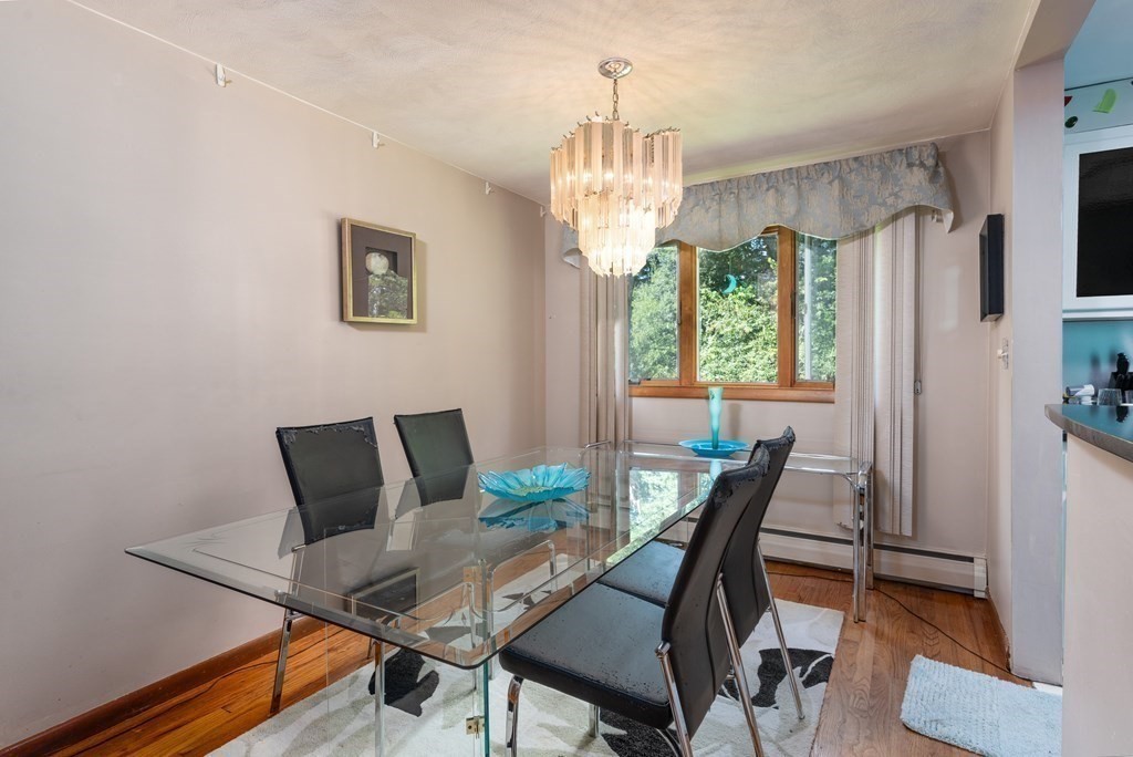 126 Baldwin Road Billerica, MA 01821 - Photo 10 of 30 a view of a dining room with furniture a chandelier and wooden floor