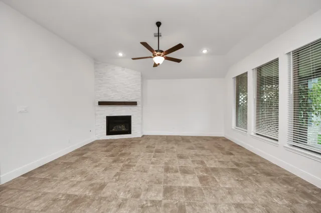 a view of a livingroom with a ceiling fan and window
